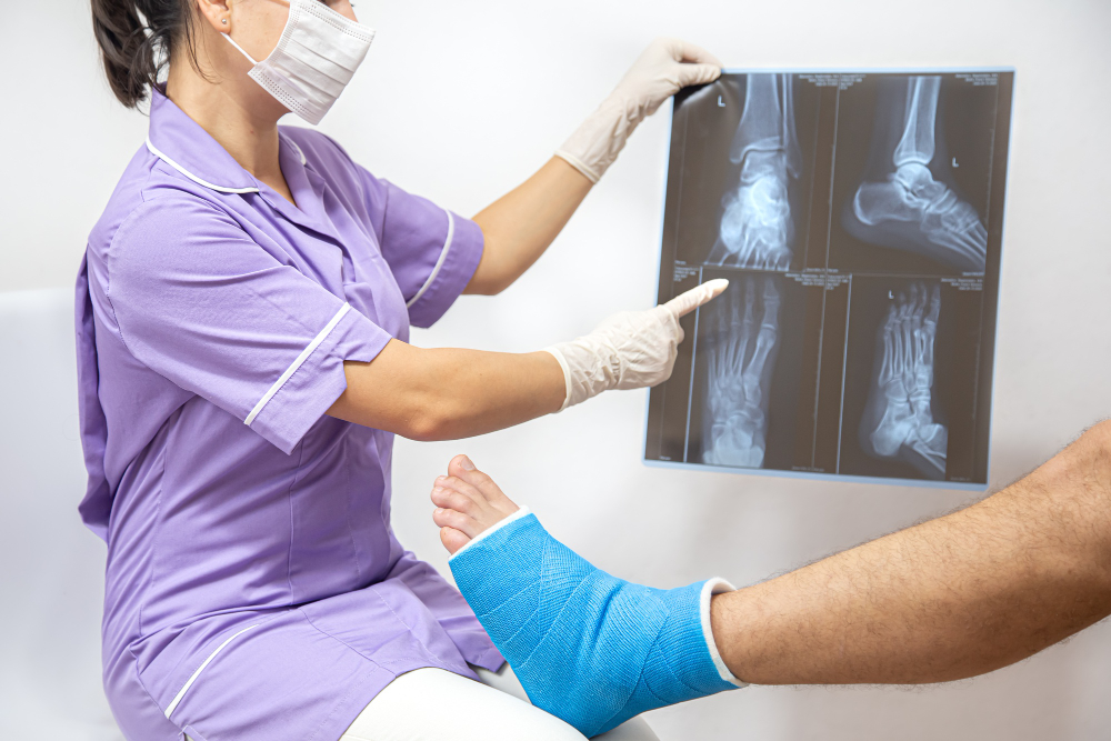 Orthopedic medical professional reviewing foot and ankle X-ray with a patient after painful orthopedic surgery